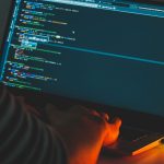 Man working on a laptop on programming
