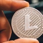 person holding litecoin