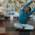 Person stretching looking at a tablet